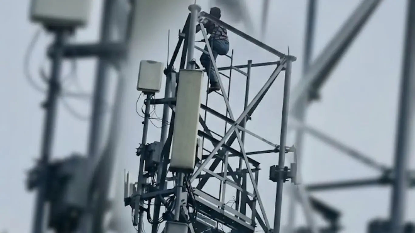 A young woman climbing a mobile tower in Uttar Pradesh Deoria district