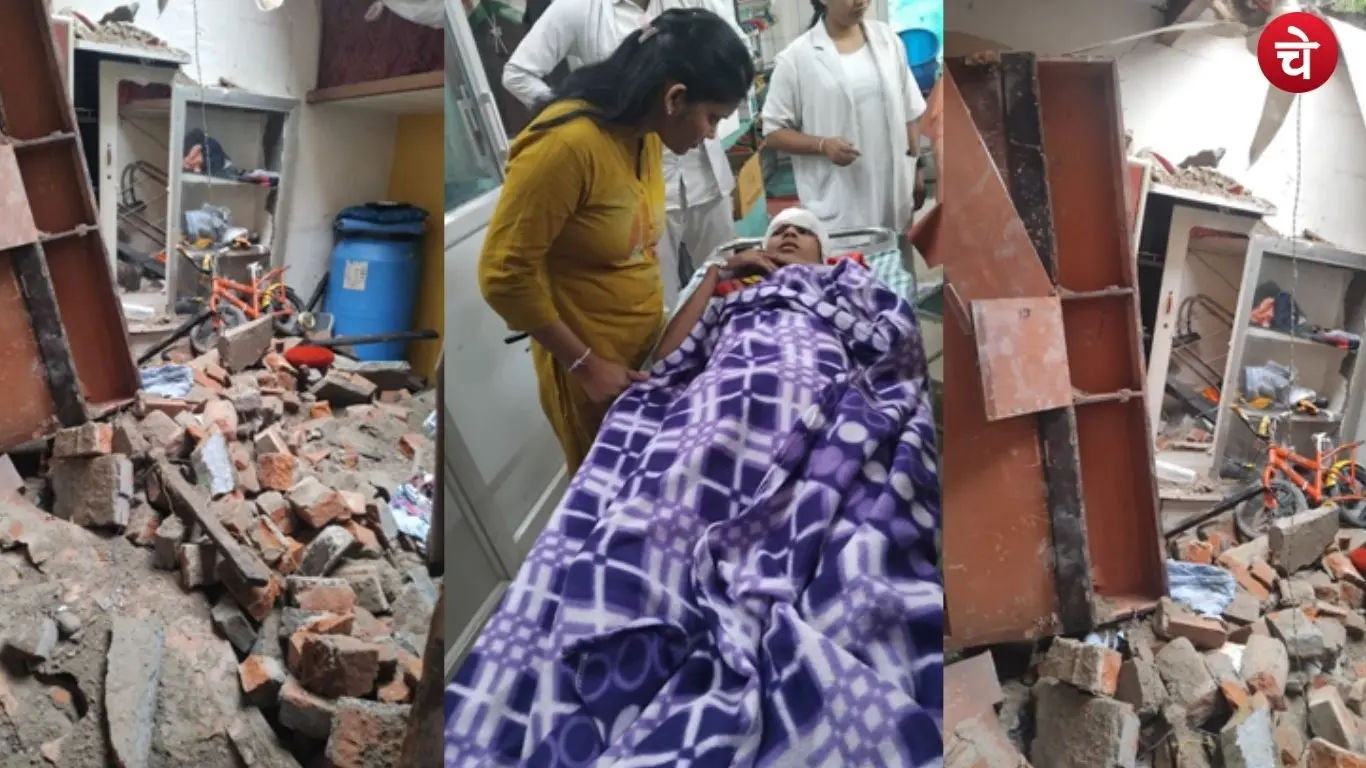 Family members taking an injured woman to hospital after the roof of a house collapsed due to continuous rain